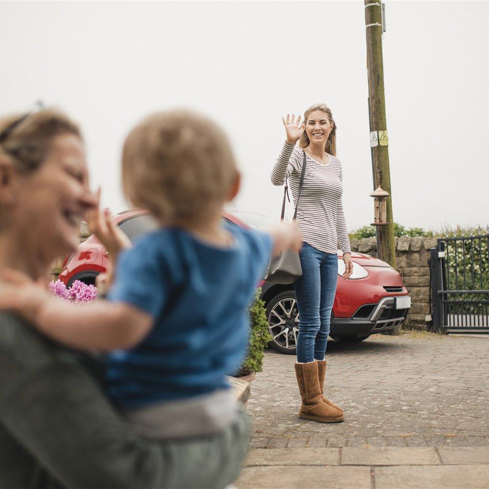 A women waves goodbye to her mother and son