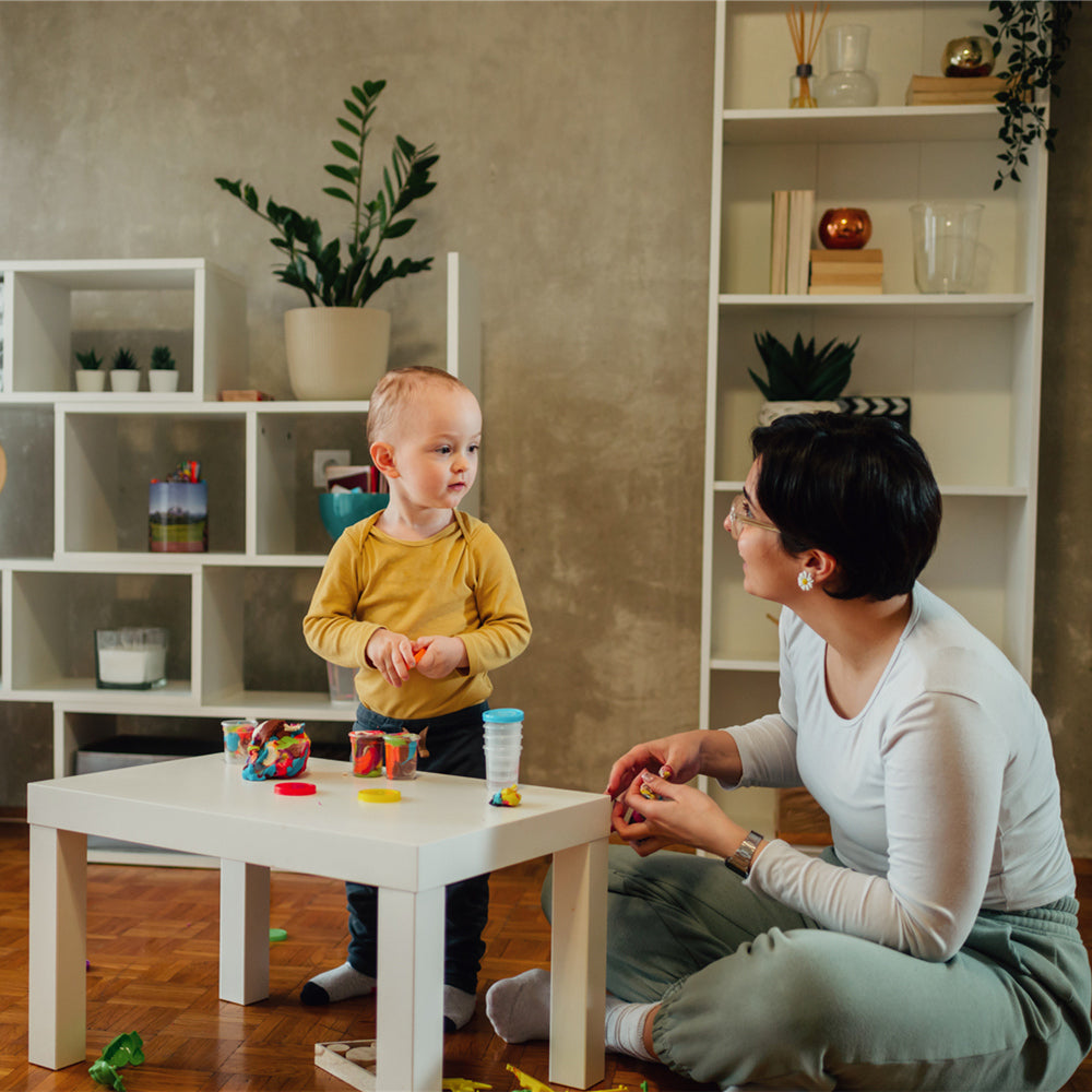 Mother and son playing with clay at home and creating art