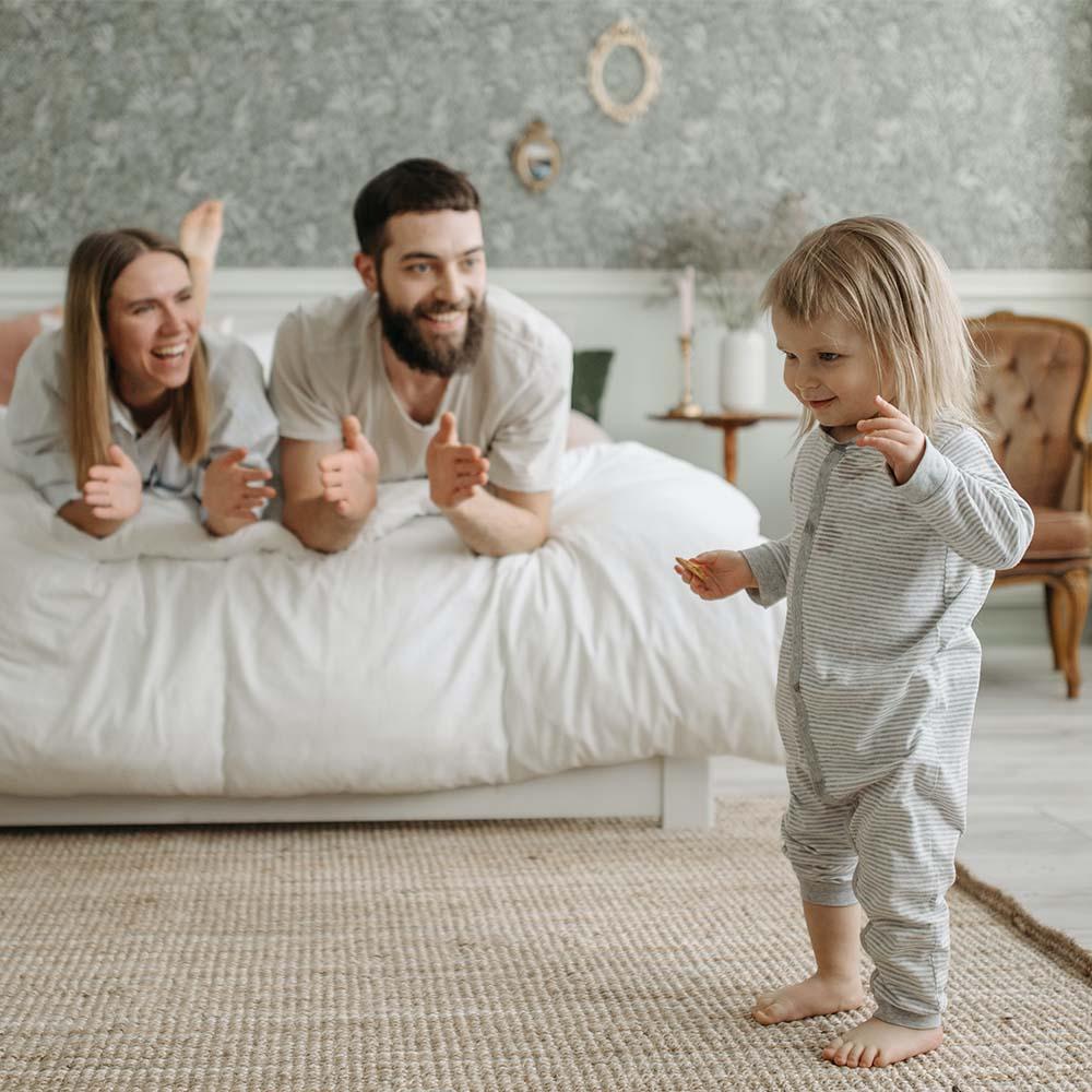 Parents cheerfully clapping  encouraging the child to express their thoughts