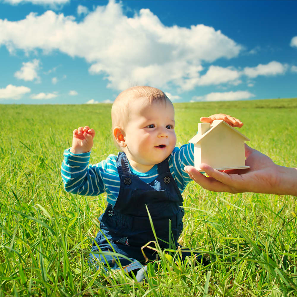 Little boy sitting in the nature with toys