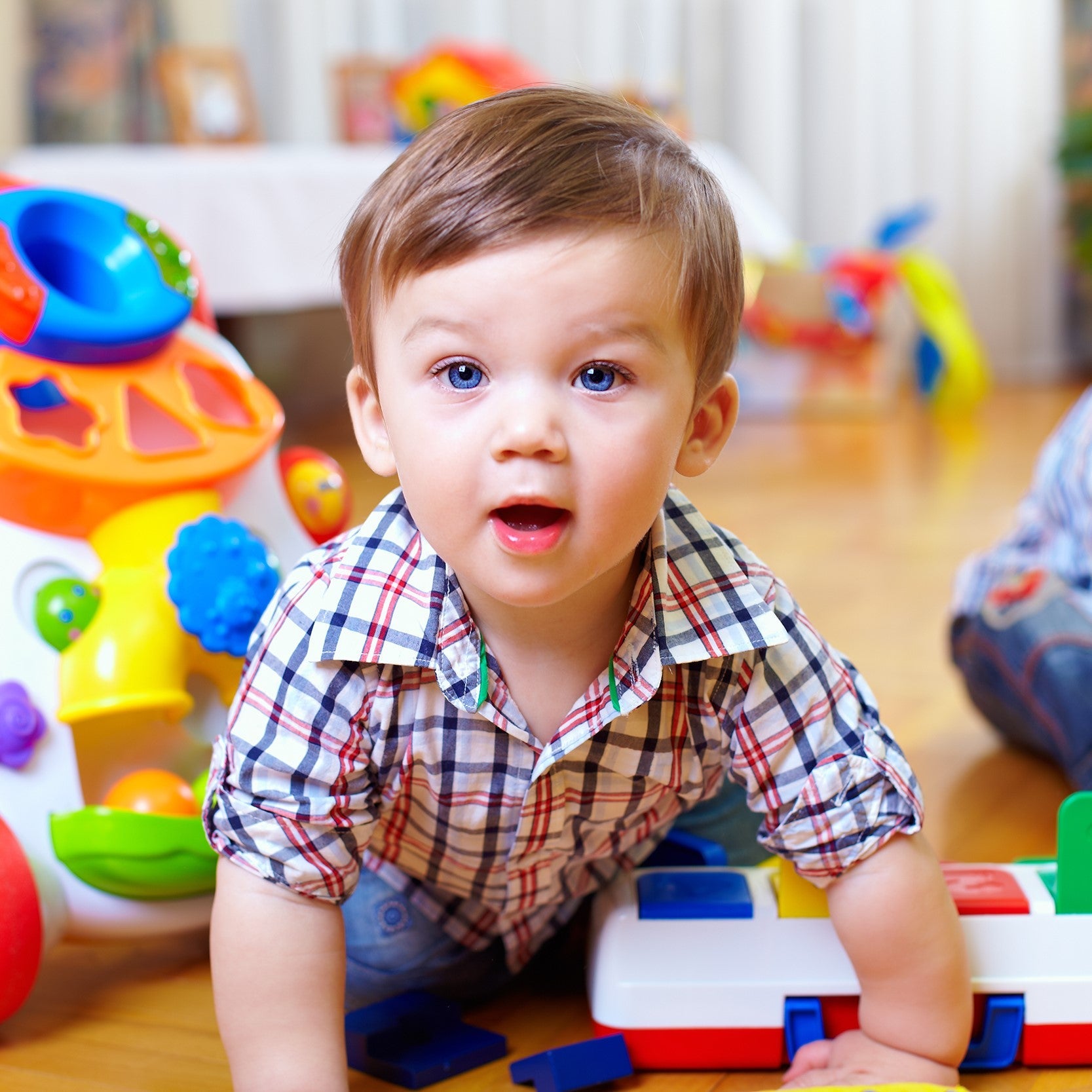 Curious baby boy is studying nursery room