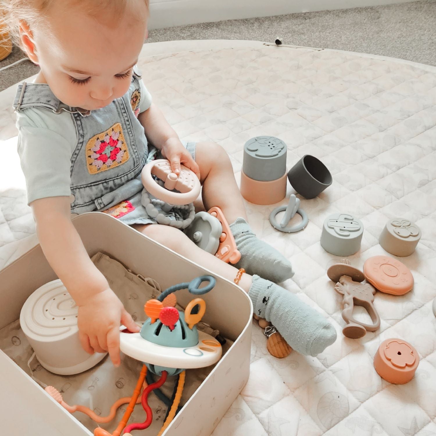 A girl is playing Moonkie playtime toys