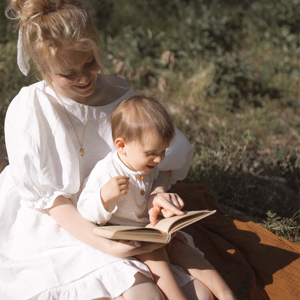 A mother is teaching her child to read
