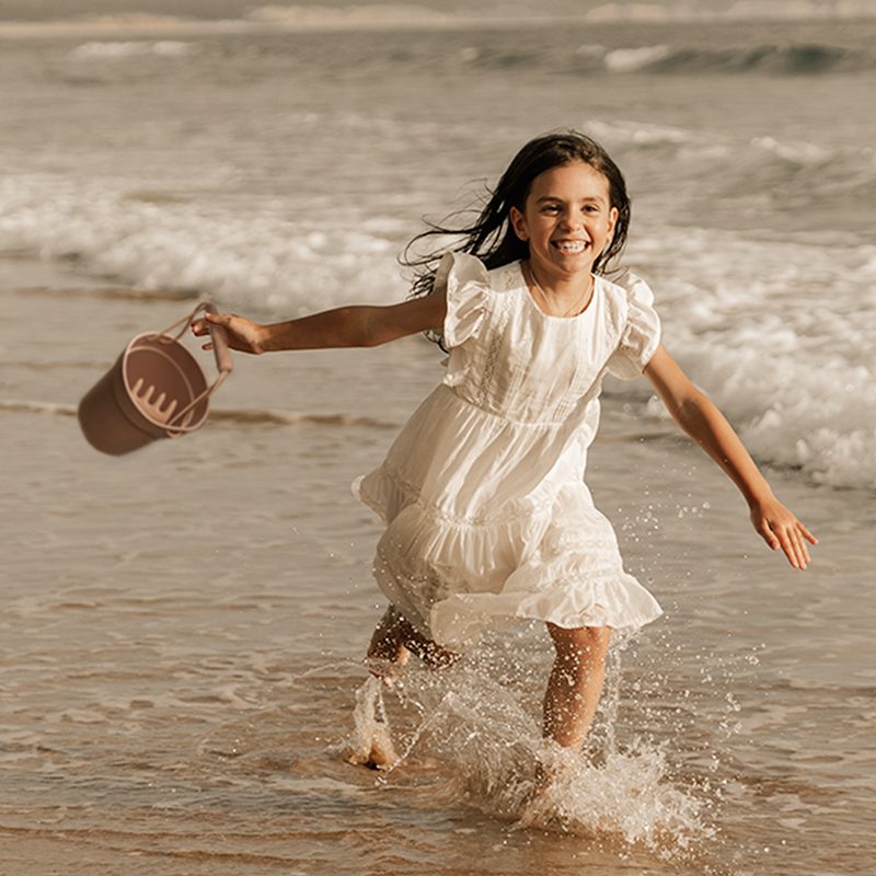 Baby Playing With Bach Toy At The Beach