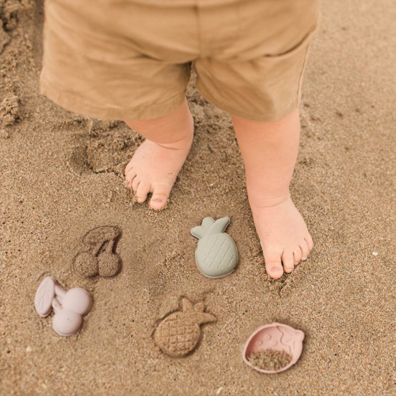 Baby playing with beach toys at the beach2