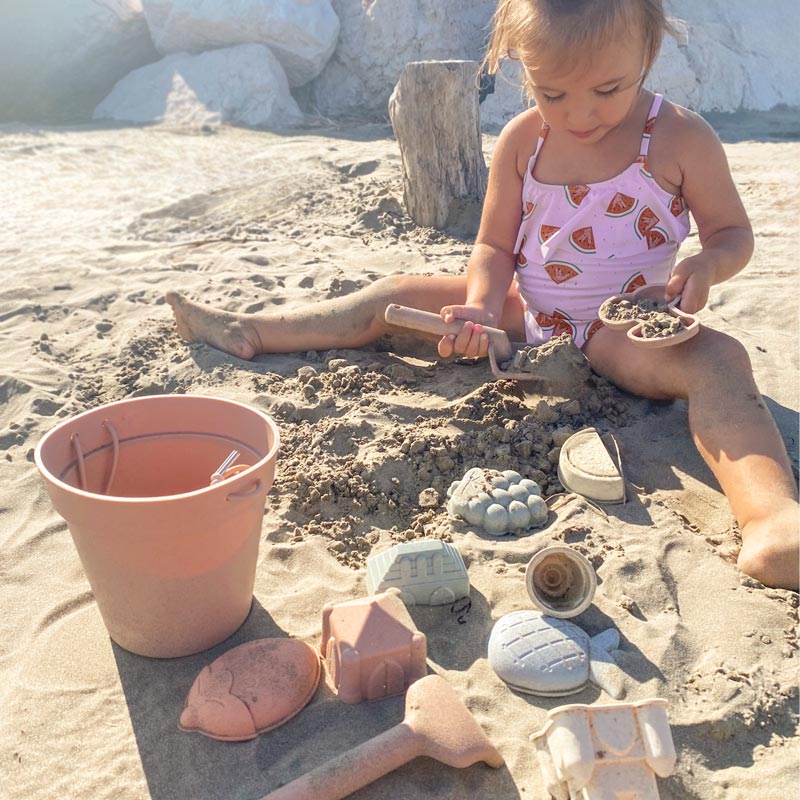 Baby playing with blush beach toys at the beach2