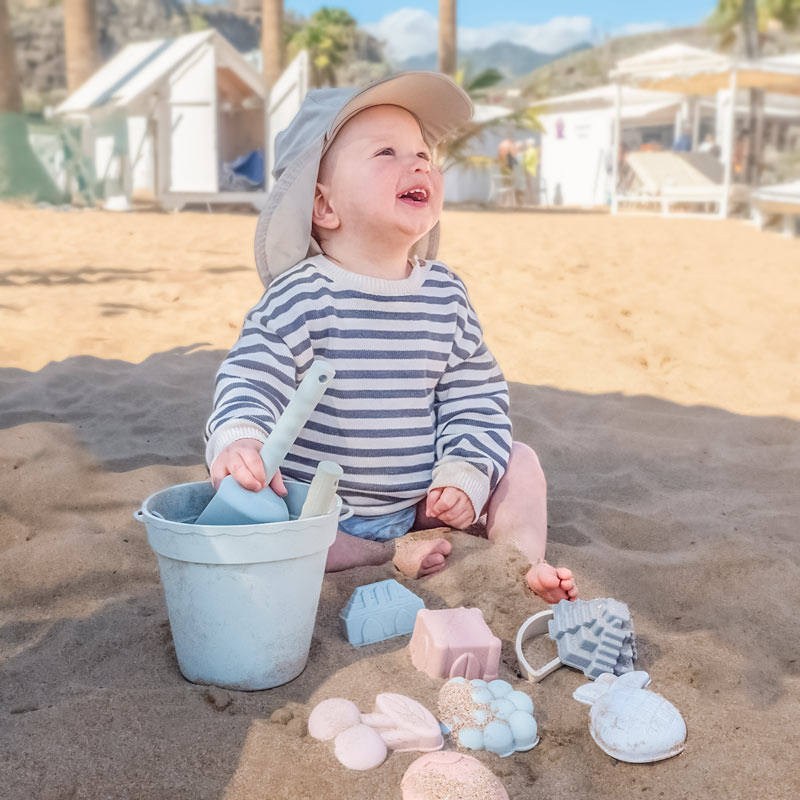 Baby playing with Ether beach toys at the beach2