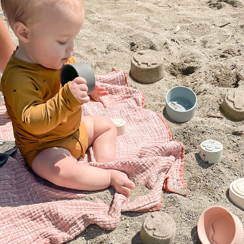 Baby Playing With Stacking Cups At the beach