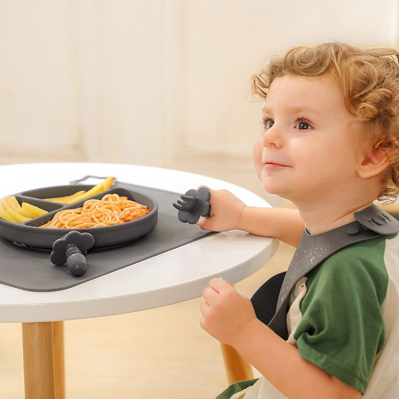 Baby Using Items From Feeding Set