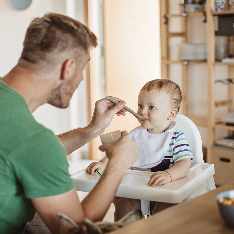 Dad is feeding his baby