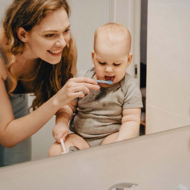 Mom Using Tongue Brush For Baby